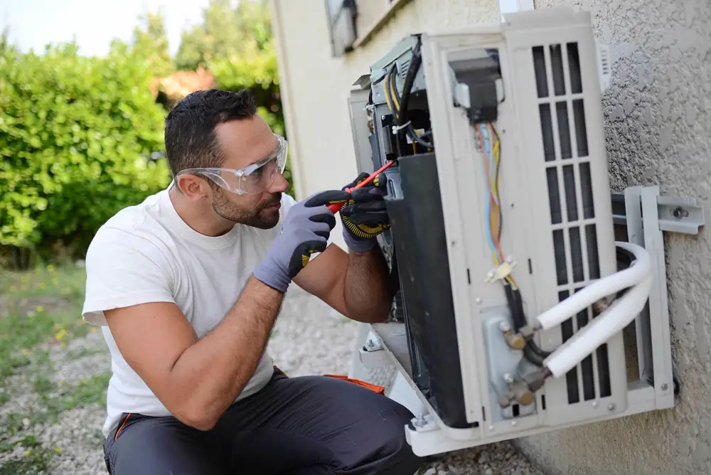 Technician repairing a residential air conditioner in Los Angeles